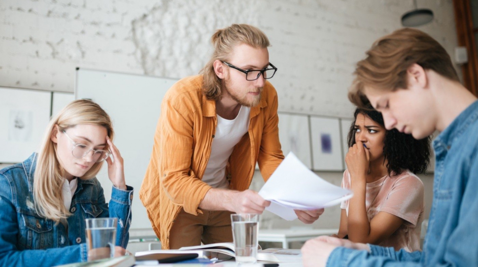 group-of-upset-students-sitting-at-the-table-with-E5YW9L4 (1)